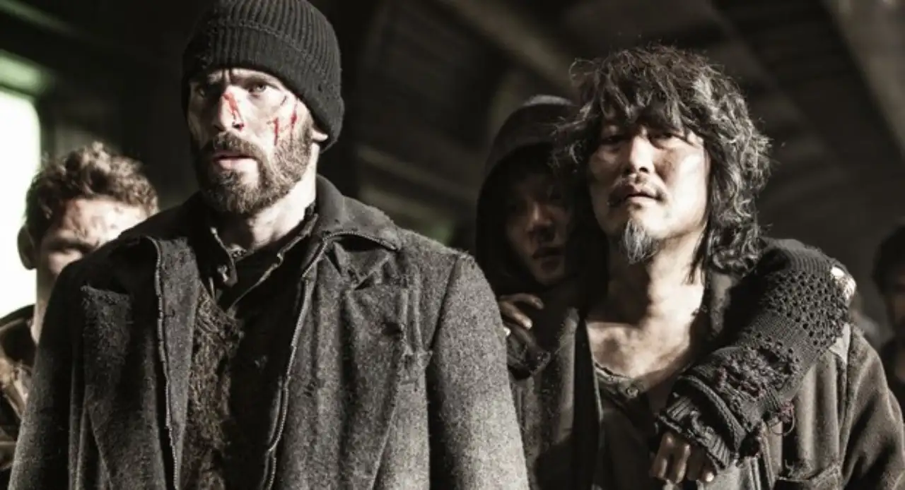 Passengers inside a dark crowded train carriage in Snowpiercer