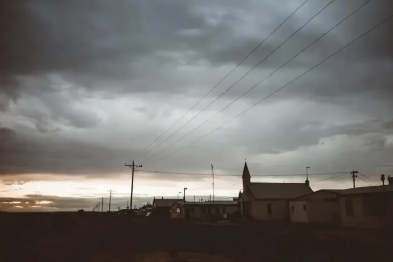 Leviticus Movie Review featured image showing an eerie rural town and church at dusk