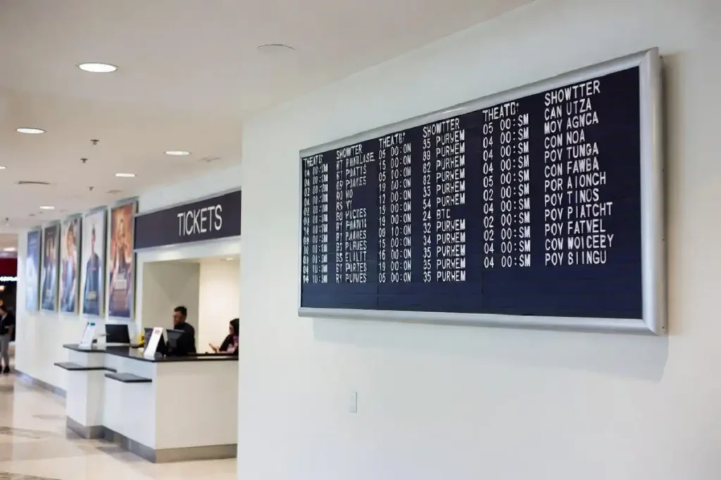 Cinema lobby display board showing new movie showtimes for June 2026 releases