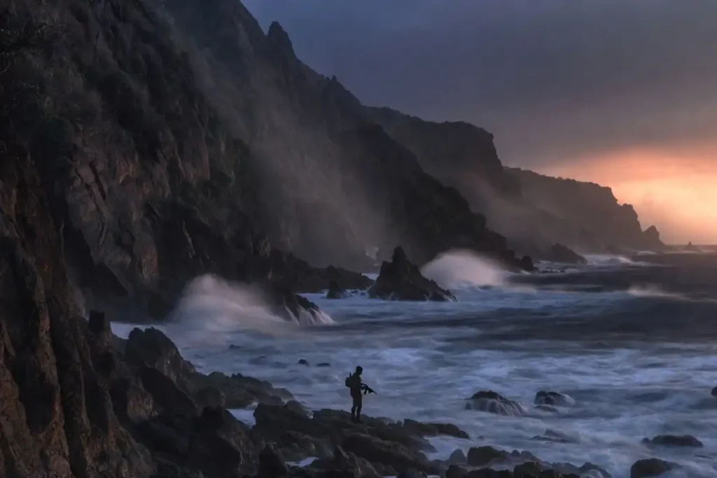 Coastal pirate action thriller setting with cliffs and stormy sea