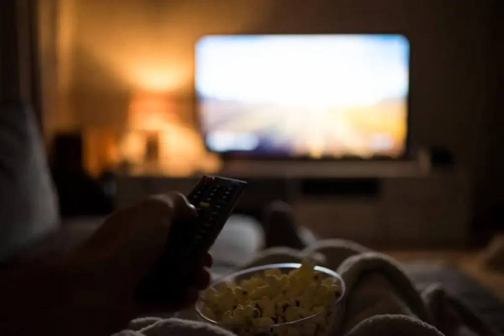TV remote and popcorn ready for a fun comedy streaming night