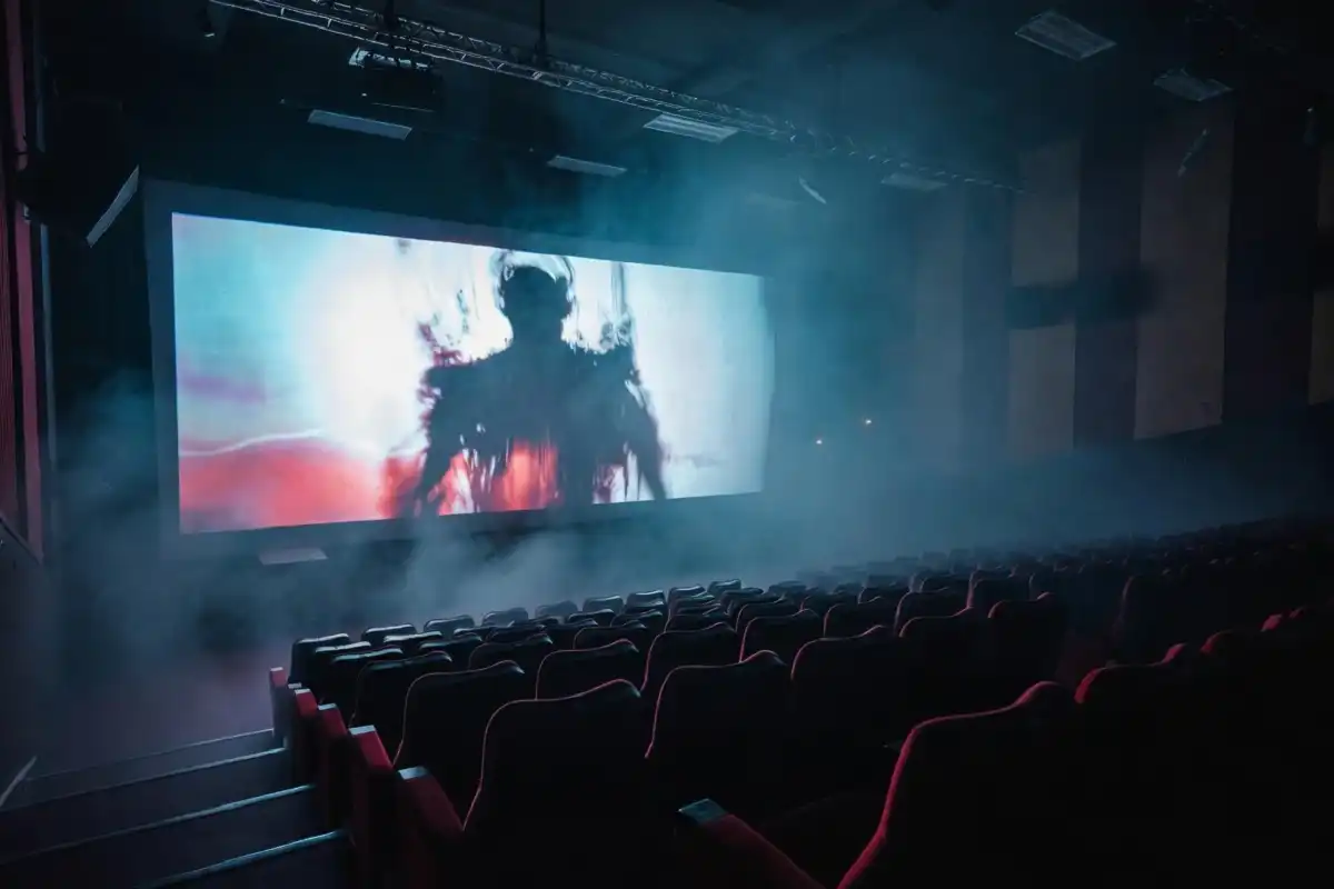 Top horror movies of 2026 shown on a glowing cinema screen in a dark theater
