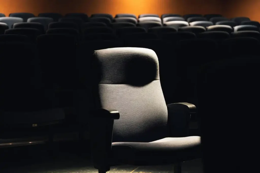 Moody theater scene representing the tone of black comedy movies