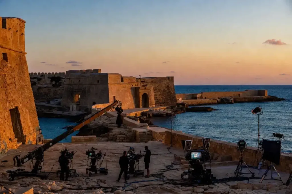 Film production crew at a Maltese fortress showing the kind of Hollywood shoots the Malta Film Commissioner attracts